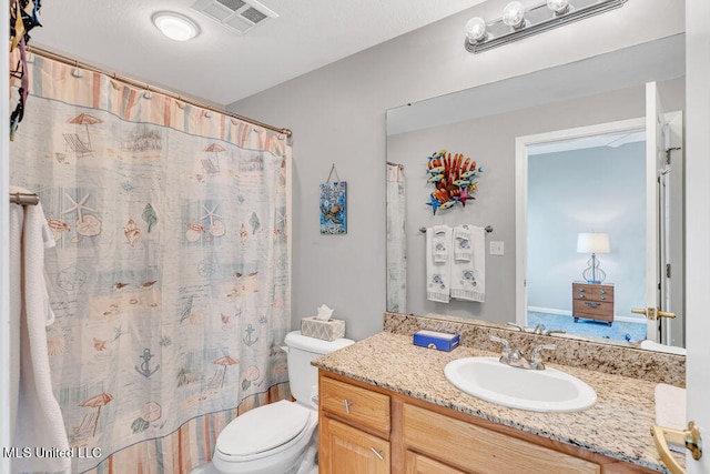 bathroom featuring vanity, toilet, and a shower with curtain