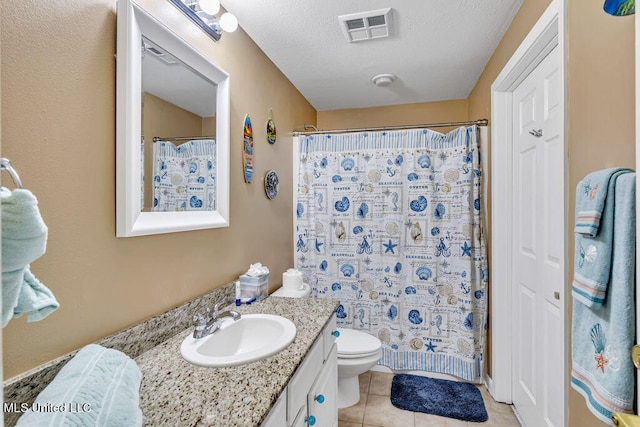 bathroom with vanity, a shower with shower curtain, toilet, and tile patterned floors