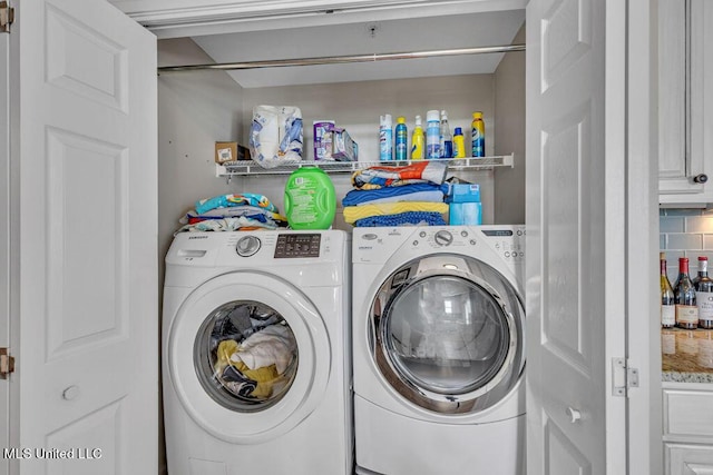 clothes washing area with laundry area and washer and clothes dryer