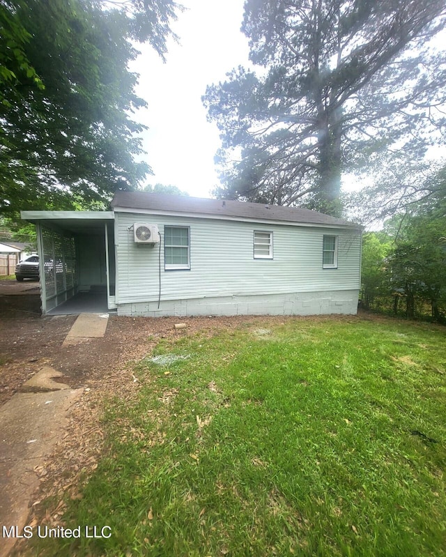 rear view of property featuring a yard and a carport