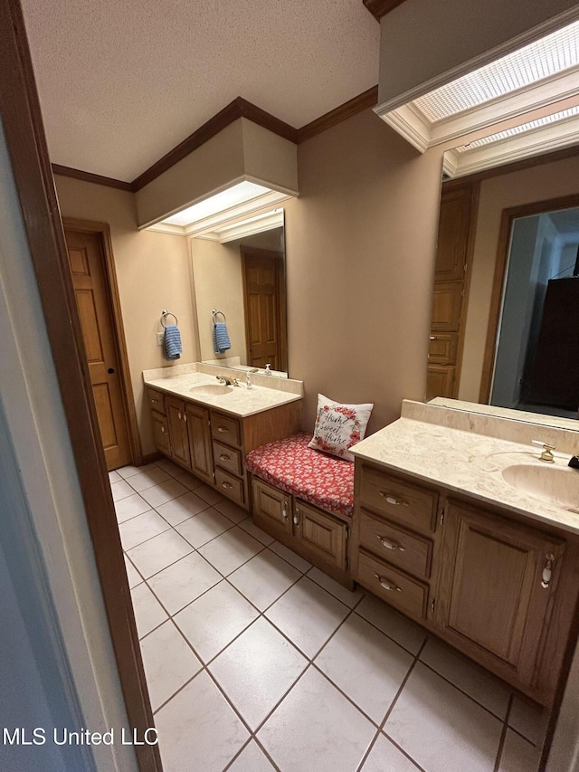 502 Frederick Dr, Cleveland, MS 38732 - bathroom with ornamental molding, tile patterned floors, two vanities, and a textured ceiling