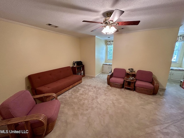 502 Frederick Dr, Cleveland, MS 38732 - carpeted living room with crown molding, a ceiling fan, a textured ceiling, and baseboards