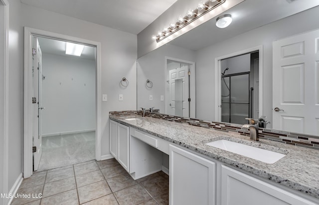 603 Charmant Pl, Ridgeland, MS 39157 - bathroom with double vanity, tile patterned floors, and backsplash