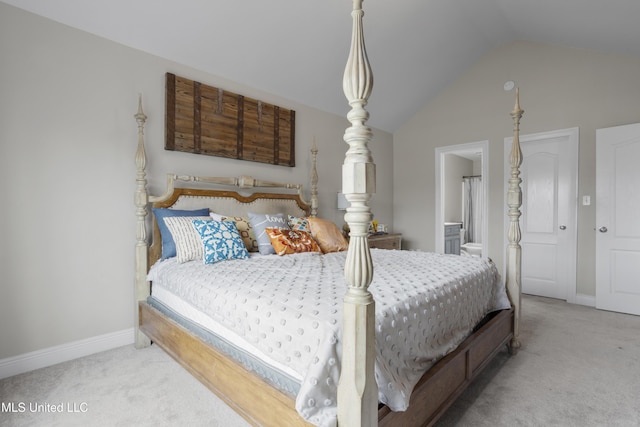 carpeted bedroom with connected bathroom and vaulted ceiling