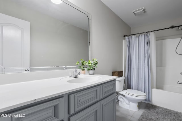 full bathroom featuring vanity, toilet, tile patterned flooring, and shower / tub combo