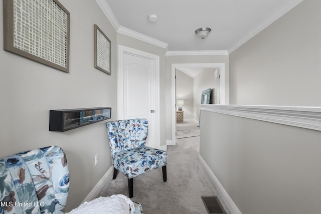 sitting room with crown molding and light carpet