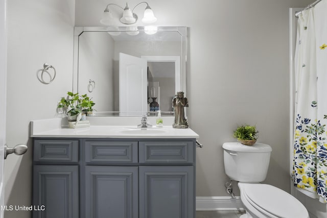 bathroom featuring vanity, a notable chandelier, and toilet