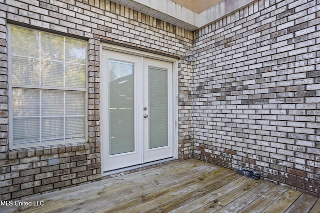 property entrance with a wooden deck and french doors