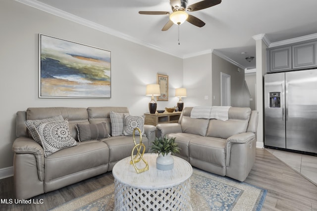 living room with tile patterned flooring, ornamental molding, and ceiling fan