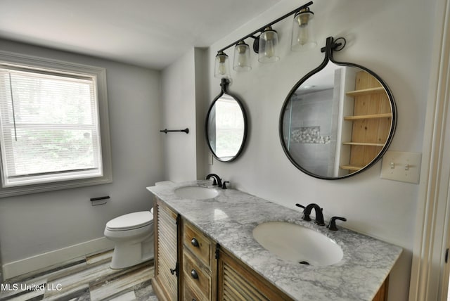3490 Sherrod Rd, Nesbit, MS 38651 - full bath featuring wood finished floors, toilet, double vanity, and baseboards