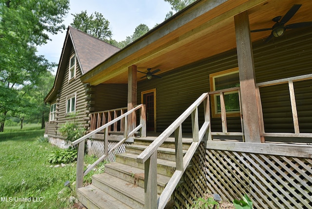 3490 Sherrod Rd, Nesbit, MS 38651 - view of exterior entry featuring ceiling fan, log exterior, and roof with shingles