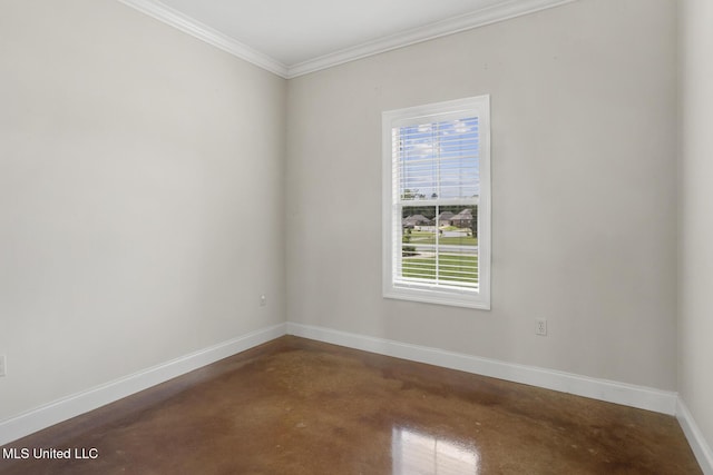 spare room featuring concrete floors, baseboards, and ornamental molding