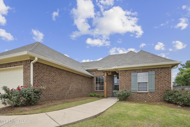 single story home with brick siding, a front lawn, and a garage