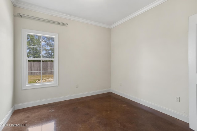 unfurnished room featuring finished concrete flooring, baseboards, and crown molding