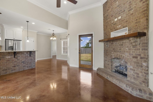 unfurnished living room featuring finished concrete floors, ceiling fan, a brick fireplace, baseboards, and ornamental molding