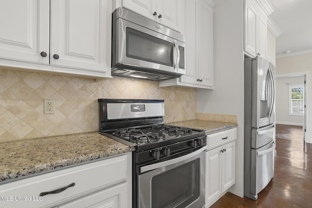 kitchen with appliances with stainless steel finishes, white cabinets, light stone counters, and crown molding