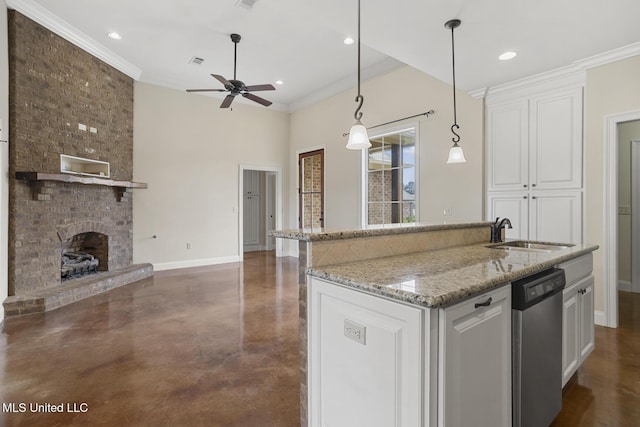 kitchen featuring a sink, dishwasher, open floor plan, concrete floors, and baseboards