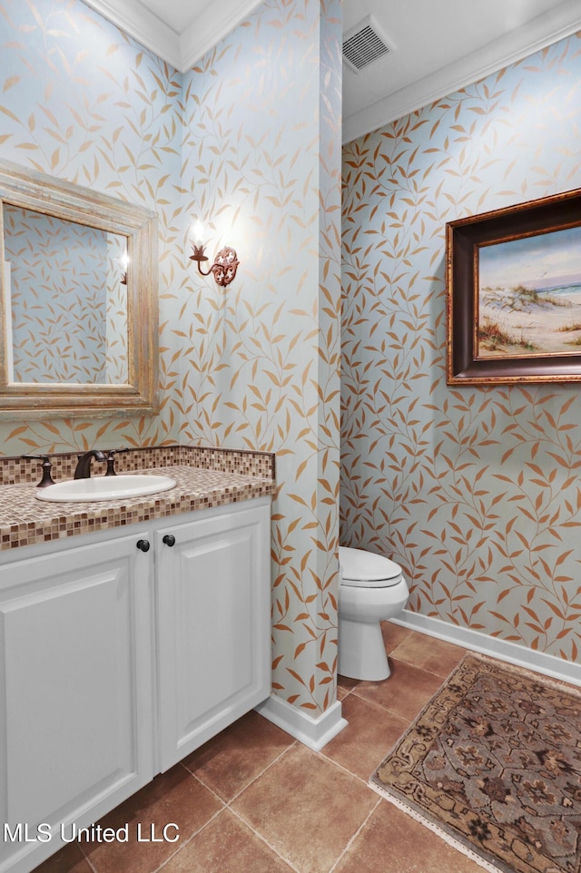 bathroom featuring ornamental molding, toilet, tile patterned flooring, and vanity