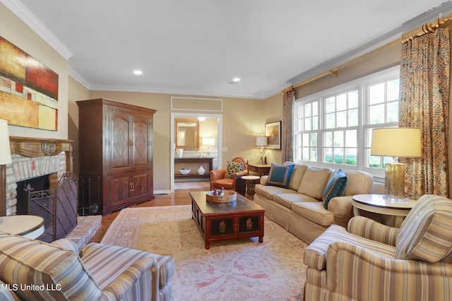 living room featuring ornamental molding, a brick fireplace, and light wood-type flooring