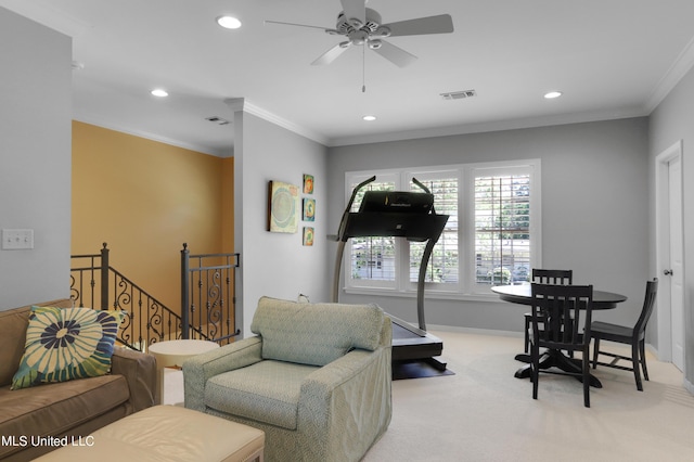 workout area with crown molding, ceiling fan, and light carpet