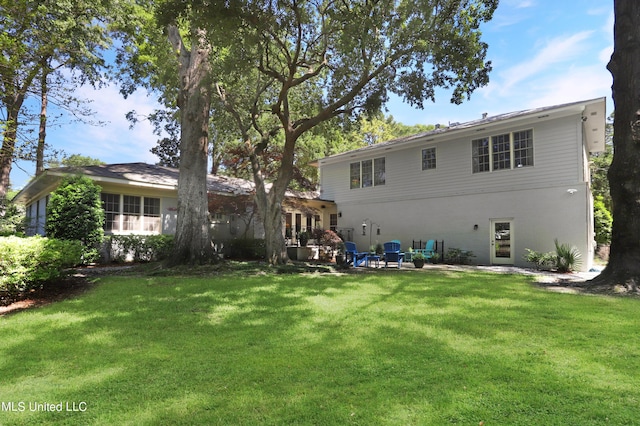 back of house with a lawn