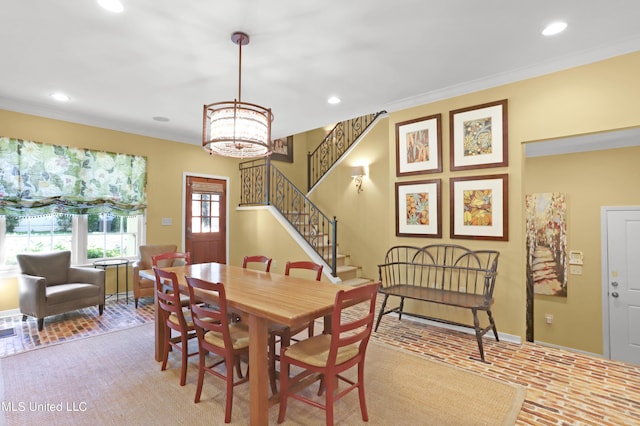 dining space featuring ornamental molding and a chandelier