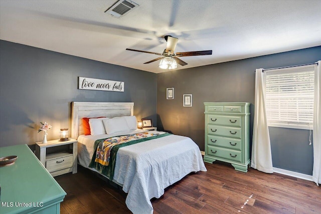 bedroom with dark wood-type flooring, baseboards, and ceiling fan