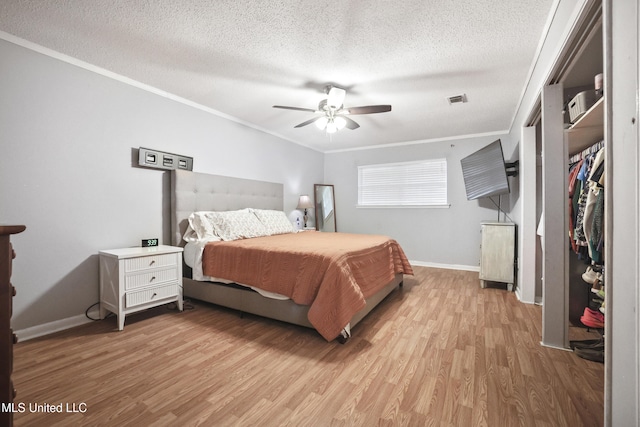 3306 Nottingham Rd, Ocean Springs, MS 39564 - bedroom with ornamental molding, wood finished floors, a textured ceiling, and a ceiling fan