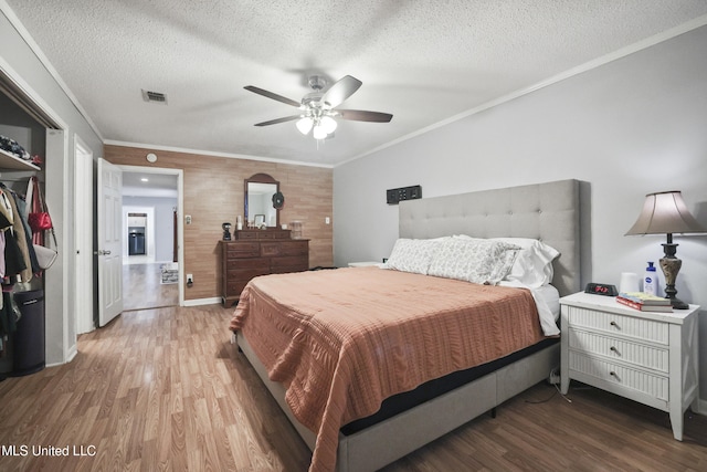 3306 Nottingham Rd, Ocean Springs, MS 39564 - bedroom featuring wood finished floors, crown molding, a textured ceiling, and ceiling fan