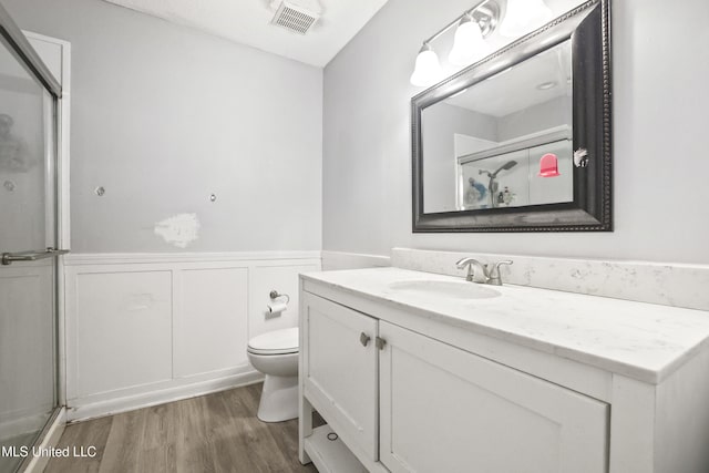 3306 Nottingham Rd, Ocean Springs, MS 39564 - full bathroom with vanity, wainscoting, wood finished floors, and a shower with door
