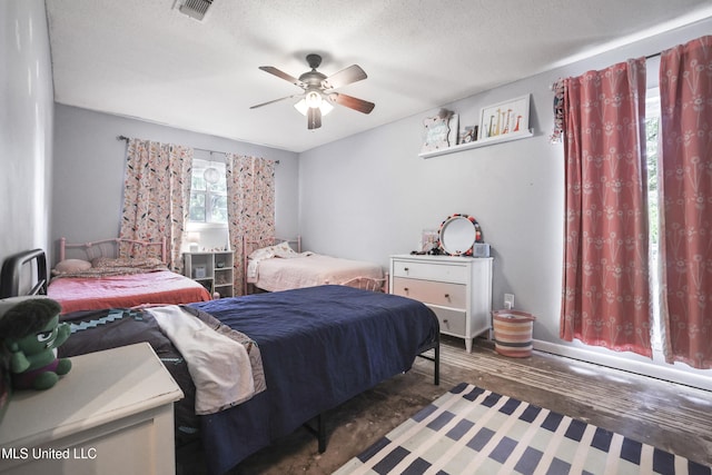 3306 Nottingham Rd, Ocean Springs, MS 39564 - bedroom with wood finished floors, a textured ceiling, and a ceiling fan