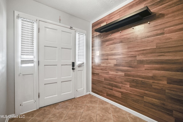 3306 Nottingham Rd, Ocean Springs, MS 39564 - entrance foyer with wooden walls, a textured ceiling, and tile patterned floors