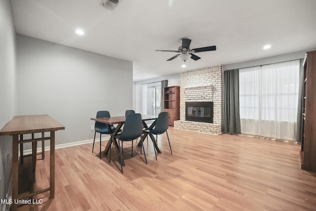 3306 Nottingham Rd, Ocean Springs, MS 39564 - dining area with light wood-type flooring, ceiling fan, a fireplace, and recessed lighting