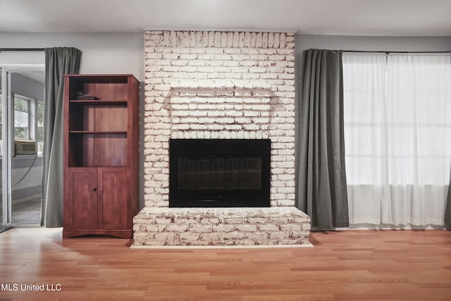 3306 Nottingham Rd, Ocean Springs, MS 39564 - unfurnished living room featuring wood finished floors and a brick fireplace