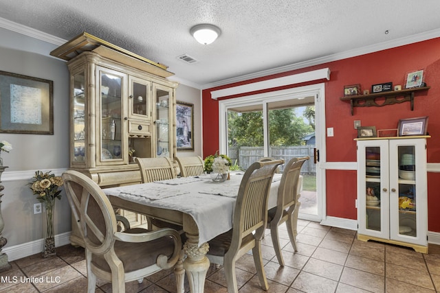306 Jamaica Dr, Ocean Springs, MS 39564 - dining space with light tile patterned floors, ornamental molding, baseboards, visible vents, and a textured ceiling