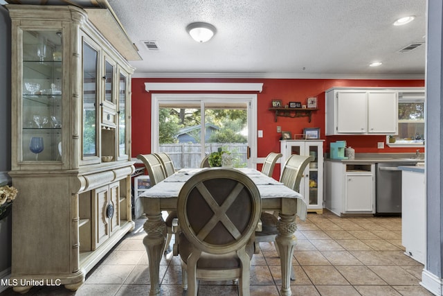 306 Jamaica Dr, Ocean Springs, MS 39564 - dining room with a textured ceiling, visible vents, and ornamental molding