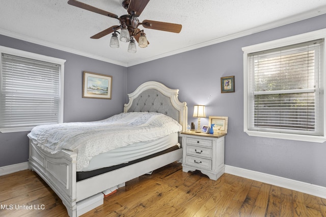 306 Jamaica Dr, Ocean Springs, MS 39564 - bedroom featuring a textured ceiling, baseboards, ornamental molding, wood finished floors, and a ceiling fan