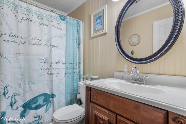 bathroom with toilet, ornamental molding, vanity, a textured ceiling, and walk in shower