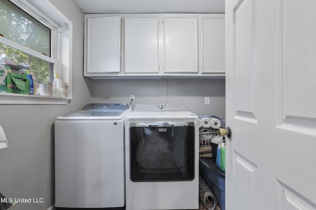 306 Jamaica Dr, Ocean Springs, MS 39564 - clothes washing area with separate washer and dryer and cabinet space