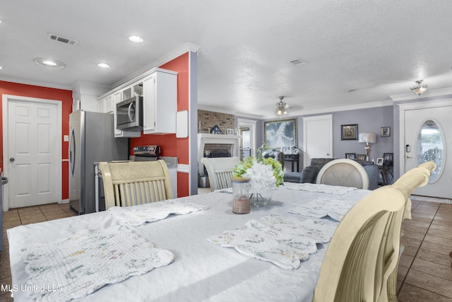 306 Jamaica Dr, Ocean Springs, MS 39564 - dining space with tile patterned floors, visible vents, ornamental molding, and a ceiling fan