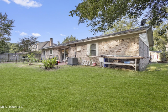 306 Jamaica Dr, Ocean Springs, MS 39564 - rear view of property featuring fence, a lawn, and brick siding