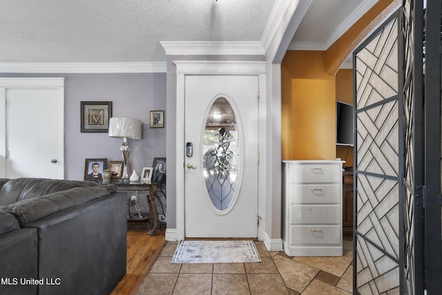 306 Jamaica Dr, Ocean Springs, MS 39564 - foyer with light wood finished floors, a textured ceiling, baseboards, ornamental molding, and arched walkways