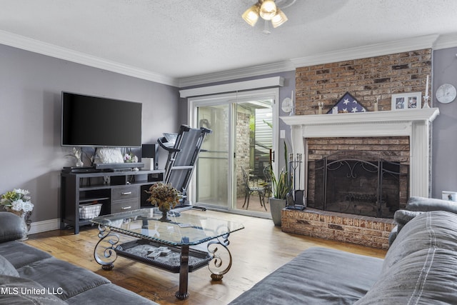 306 Jamaica Dr, Ocean Springs, MS 39564 - living room with a textured ceiling, wood finished floors, ornamental molding, and a brick fireplace