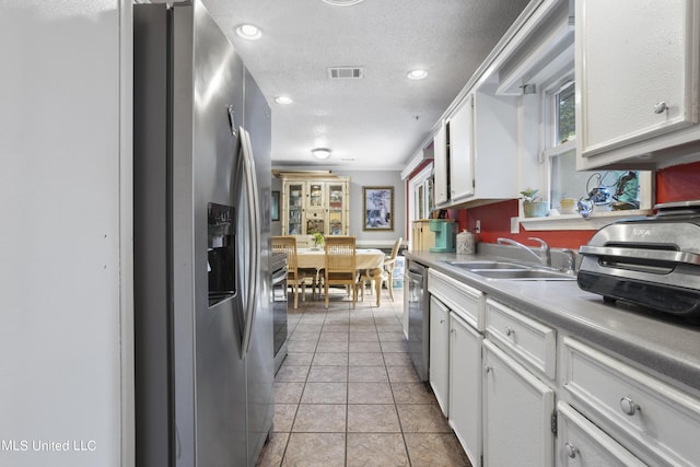 306 Jamaica Dr, Ocean Springs, MS 39564 - kitchen featuring a sink, stainless steel appliances, visible vents, white cabinetry, and light countertops