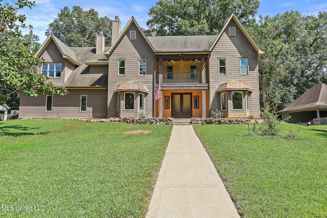 view of front of property with a balcony and a front lawn