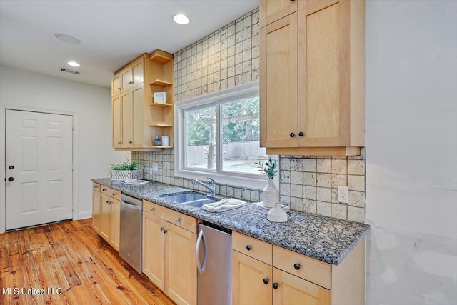 kitchen featuring light brown cabinetry, backsplash, sink, light wood-type flooring, and stainless steel dishwasher