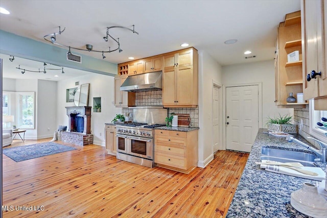 kitchen with tasteful backsplash, light brown cabinetry, sink, light hardwood / wood-style floors, and double oven range