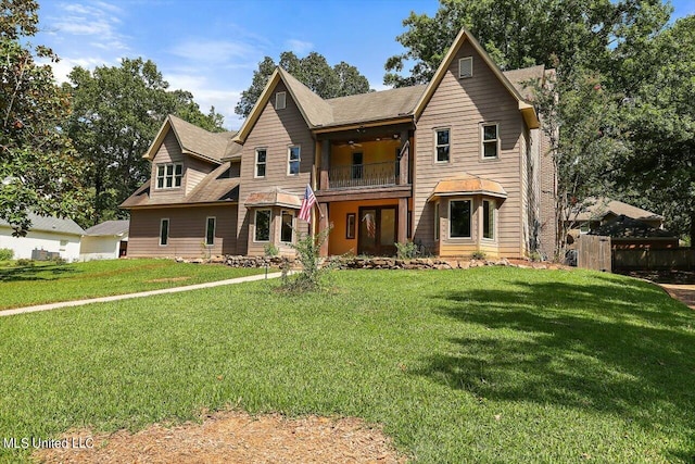 view of front of property featuring a front yard and a balcony