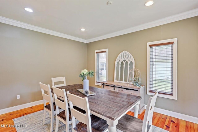 dining space featuring crown molding and light wood-type flooring