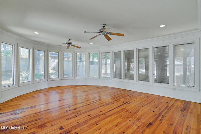 unfurnished sunroom featuring ceiling fan